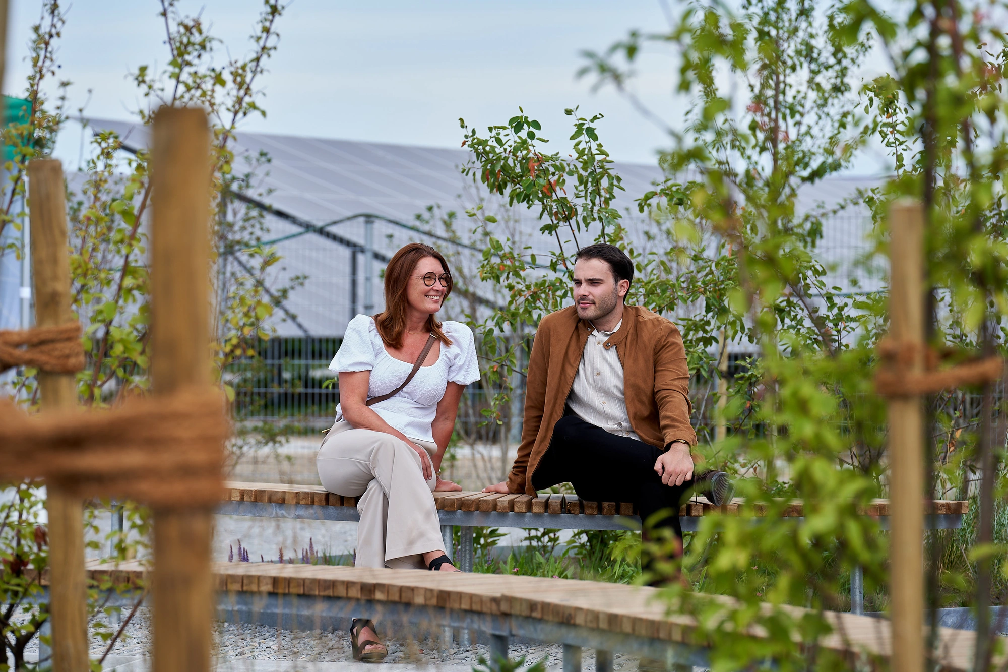 Two people seated in front of solar park